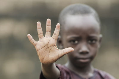 Portrait of boy with tattoo on hand