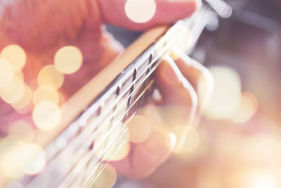 Cropped image of man playing guitar