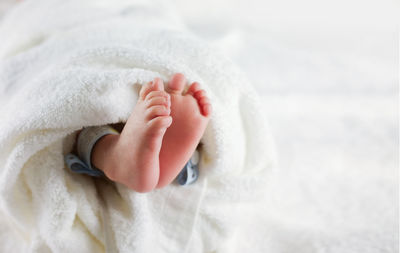 Close-up of hand holding baby feet