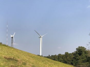 Windmill on field against clear sky