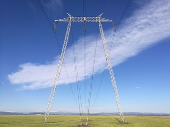 Low angle view of field against blue sky