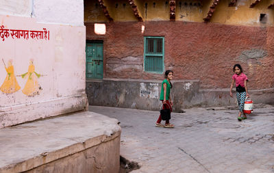 People walking on building wall