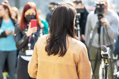 Rear view of woman photographing