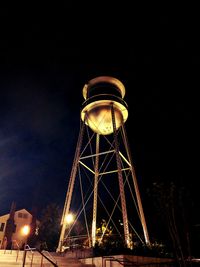 Low angle view of water tower against sky at night