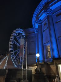 Low angle view of illuminated ferris wheel at night