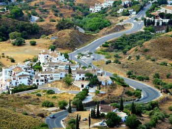 High angle view of road amidst trees and buildings