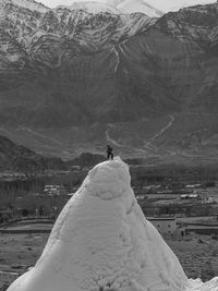 Man on snowcapped mountain peak