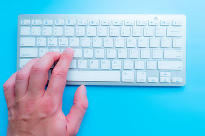 Cropped hands typing on keyboard