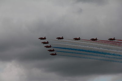 Low angle view of airplane flying against sky