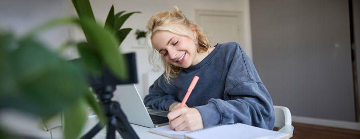 Portrait of young woman using mobile phone