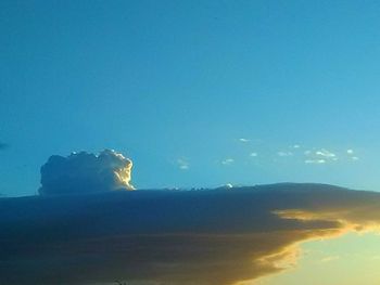 Low angle view of mountain against blue sky