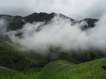 Scenic view of waterfall against sky