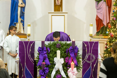 Priest kissing on table in church