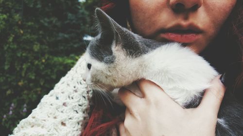 Midsection of woman holding cat