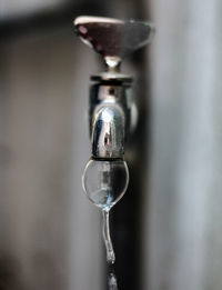 Close-up of water faucet against blurred background