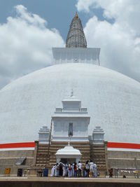 Group of people outside temple against building
