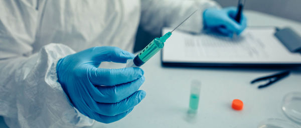 Scientist in protective suit working over chemical at laboratory