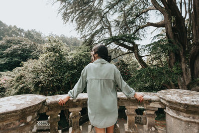 Rear view of woman looking at trees