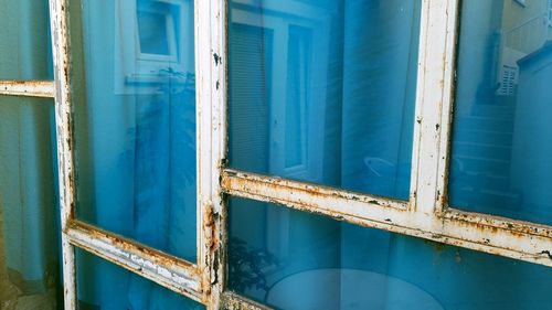 Close-up of open window of old building