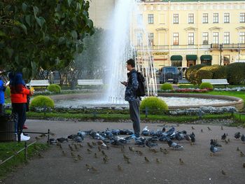 People in front of fountain in park