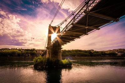 Bridge over river during sunset