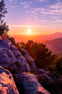 Scenic view of rocks against sky during sunset