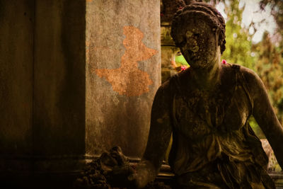 Statue of buddha against wall