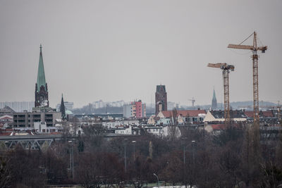 Buildings in city against clear sky