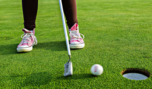 Low section of man standing on golf course