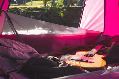 Man playing guitar on bed