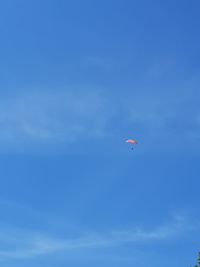 Low angle view of kite flying in blue sky