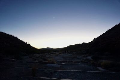 Scenic view of mountains against clear blue sky