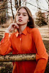 Portrait of beautiful young woman standing outdoors