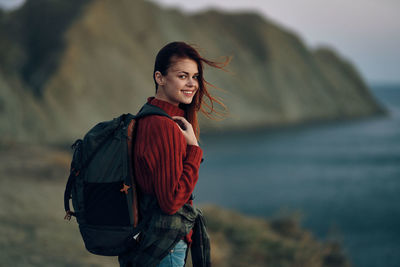 Portrait of smiling young woman standing outdoors