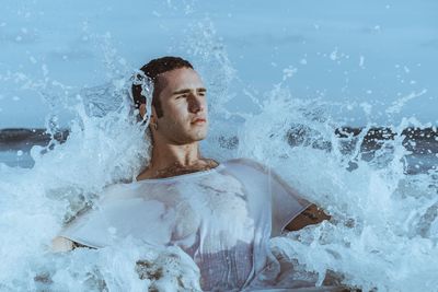 Portrait of shirtless man in sea