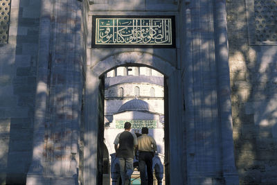 Rear view of people walking in building