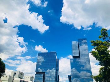 Low angle view of buildings against cloudy sky