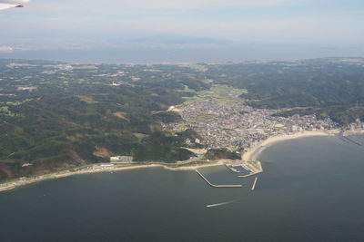 High angle view of sea and landscape against sky