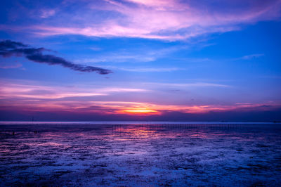 Scenic view of sea against romantic sky at sunset