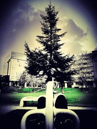 Cars on road against cloudy sky