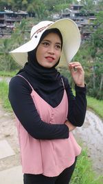 Portrait of beautiful young woman wearing hat