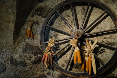 Close-up of old wheel against wall