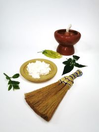 High angle view of tea cup on table against white background