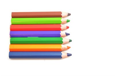 Multi colored pencils against white background