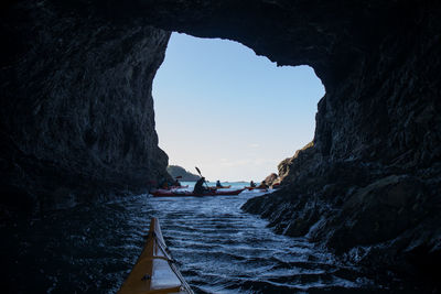 Low angle view of cave against sky