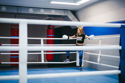 Young woman holding standing in boxing ring
