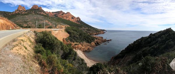 Scenic view of sea and mountains against sky