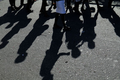 Low section of man standing on shadow