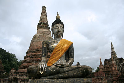 Statue of temple against building