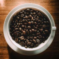 High angle view of coffee beans in bowl on table